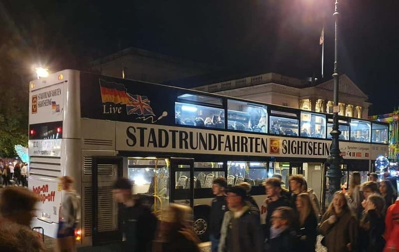 Berlin: Bus Tour by Night with Live Commentary - The Brandenburg Gate under projected light